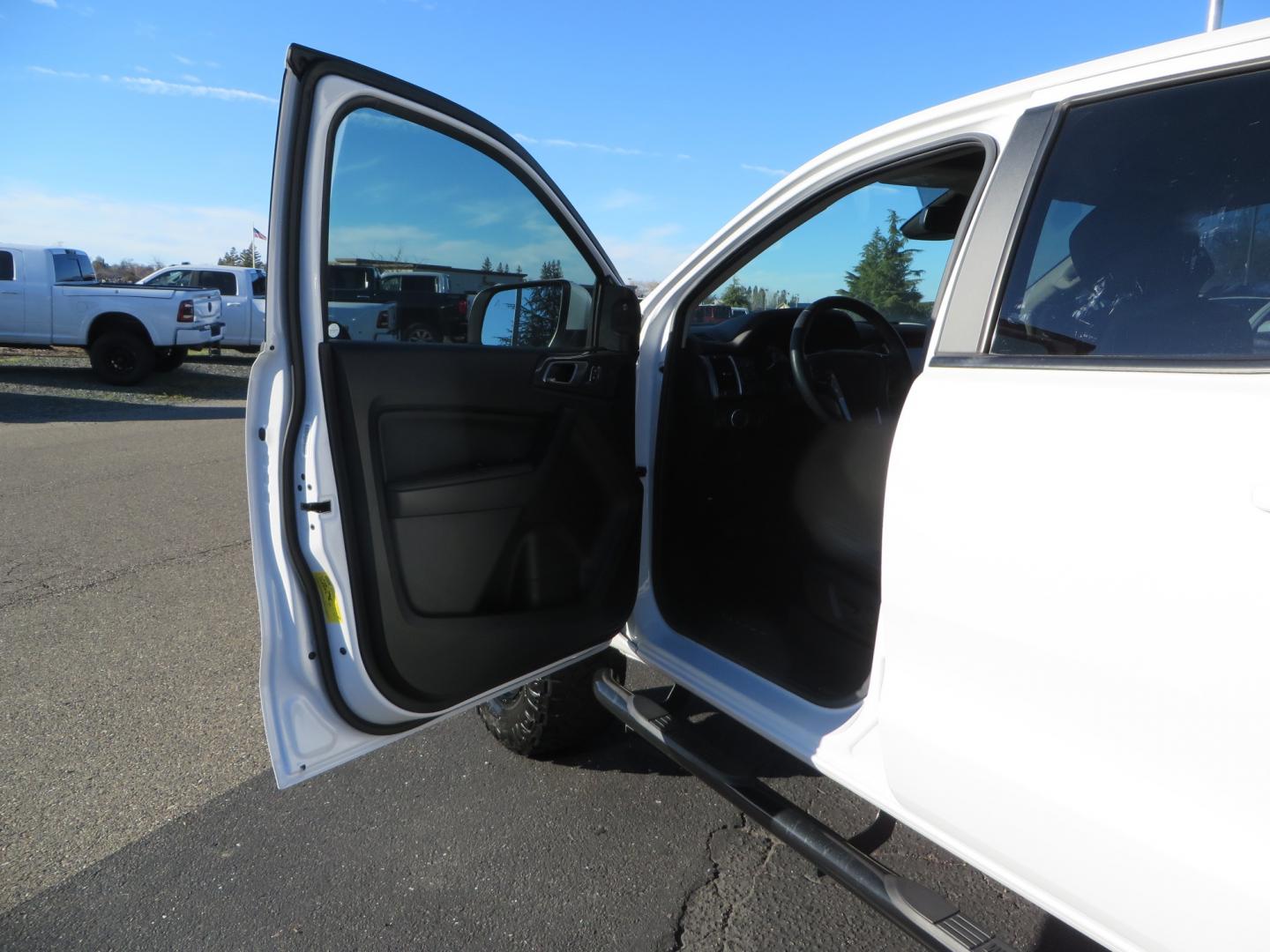 2019 White /Black Ford Ranger Lariat (1FTER4FHXKL) with an 2.3L engine, automatic transmission, located at 2630 Grass Valley Highway, Auburn, CA, 95603, (530) 508-5100, 38.937893, -121.095482 - Features a Fabtech suspension system, Fuel Offroad wheels, Nitto Ridge Grappler tires, Westin Running boards, and a Bakflip. - Photo#12